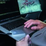 Man editing video in car using the Samsung Portable SSD T7 Touch