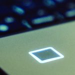 Close up of Samsung Portable SSD T7 Touch on laptop keyboard