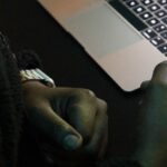 Samsung Portable SSD T7 Touch in man's hand at editing desk