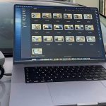 Samsung T7 Touch Portable SSD next to laptop and drone on bonnet of car